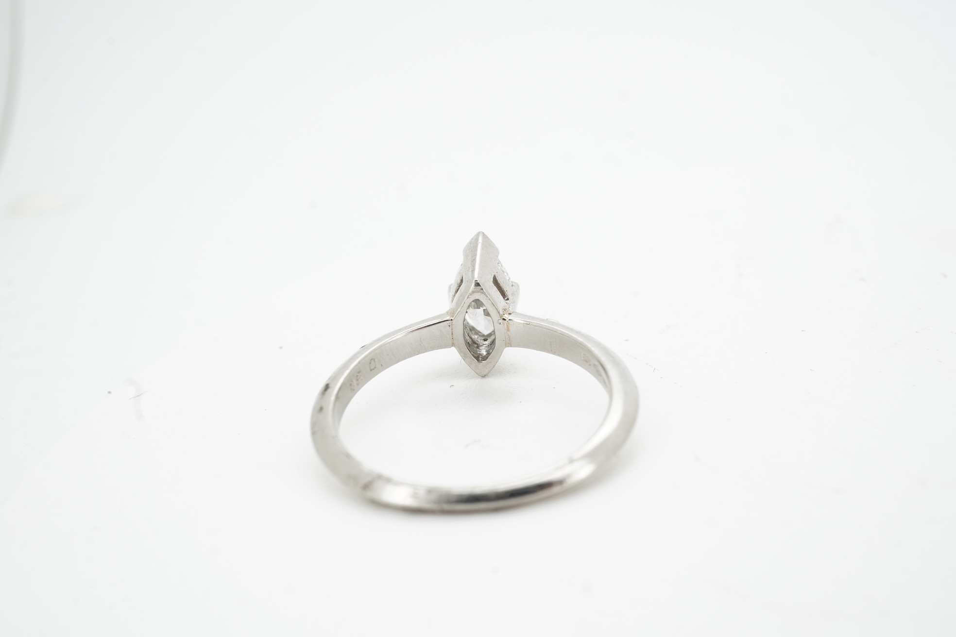 A diamond ring, claw-set with a marquise-shaped diamond weighing approximately 0.50 carats, mounted in platinum, size L, British hallmarks, gross weight approximately 4 grams